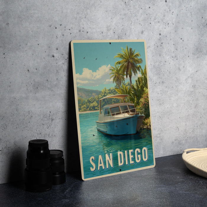 A framed vintage-style poster of a boat on a tropical beach, with palm trees and a blue sky in the background, is displayed on a wall.