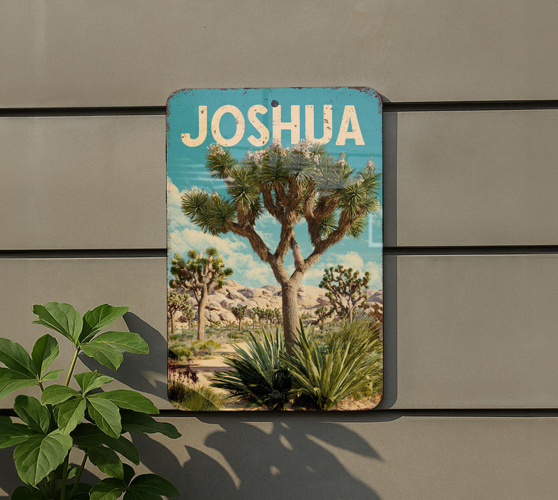 A metal sign with a desert landscape featuring a Joshua tree and other desert plants, mounted on a wall.