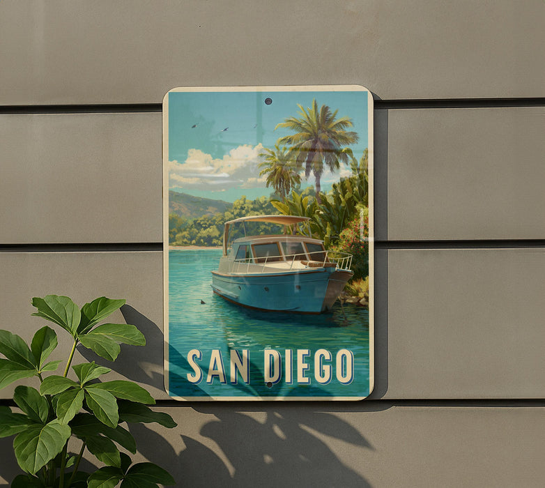 A metal sign with a picture of a boat on a body of water, surrounded by palm trees, with the text "SAN DIEGO" displayed prominently.