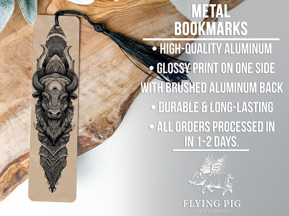 a metal bookmark with a detailed illustration of a horned creature, possibly a bison or buffalo, on it. The bookmark is placed on a wooden surface, and there is text describing the bookmark's features and pricing information.
