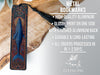 a metal bookmark with a detailed design, placed on a wooden surface.