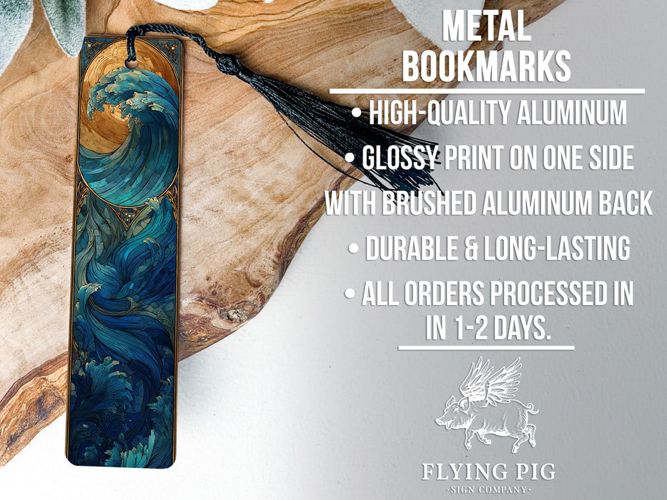 a metal bookmark with a detailed blue wave design, placed on a wooden surface.