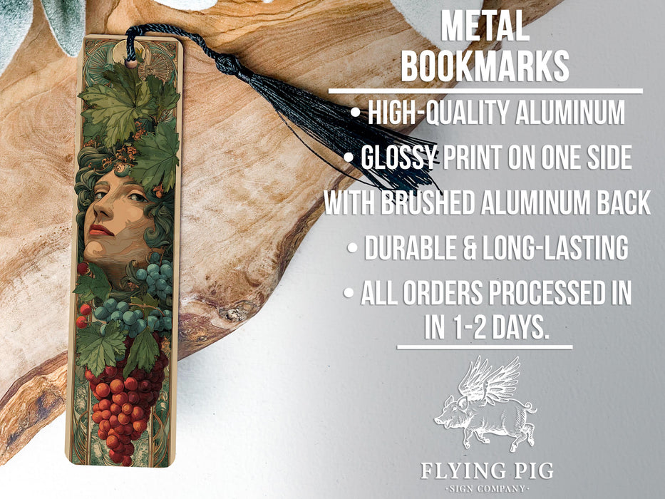 a metal bookmark with a woman's face and a grape vine design.