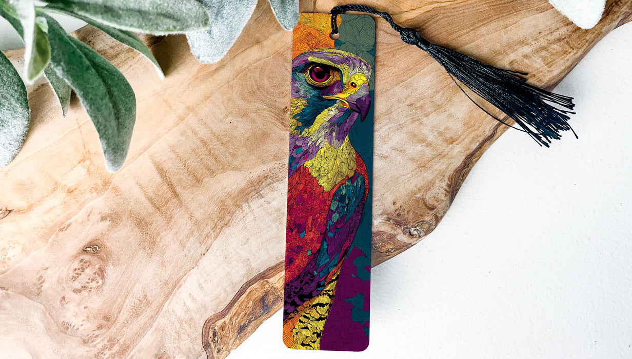 A colorful, abstract bird-like design on a bookmark, with a black tassel hanging from the top.