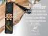 a metal bookmark with a floral design, placed on a wooden surface.