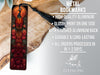 a metal bookmark with a detailed design, placed on a wooden surface.