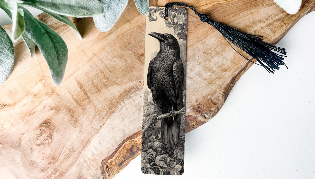 A wooden surface with a black and white illustration of a bird perched on a branch, accompanied by a black tassel.