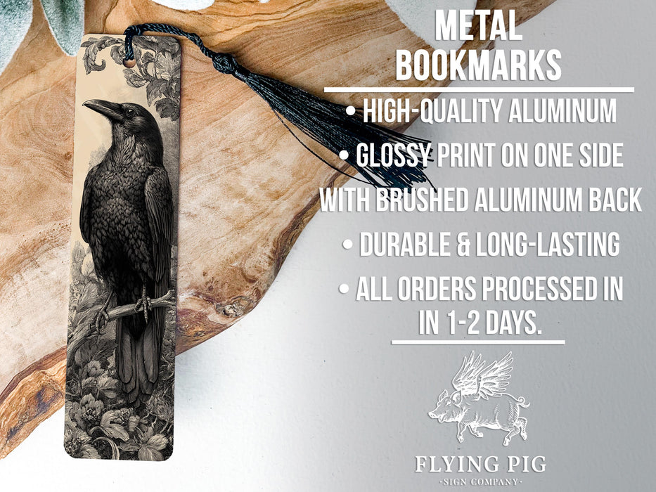 a metal bookmark with a black and white illustration of a bird perched on a branch.