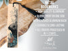 a metal bookmark with a detailed illustration of a seal on it, placed on a wooden surface.