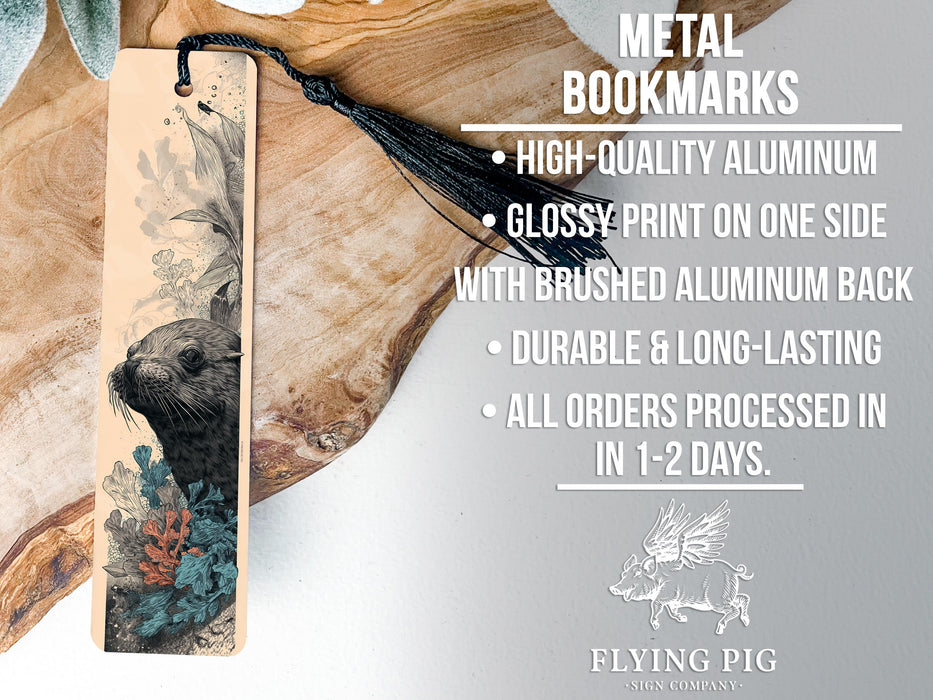 a metal bookmark with a detailed illustration of a seal on it, placed on a wooden surface.