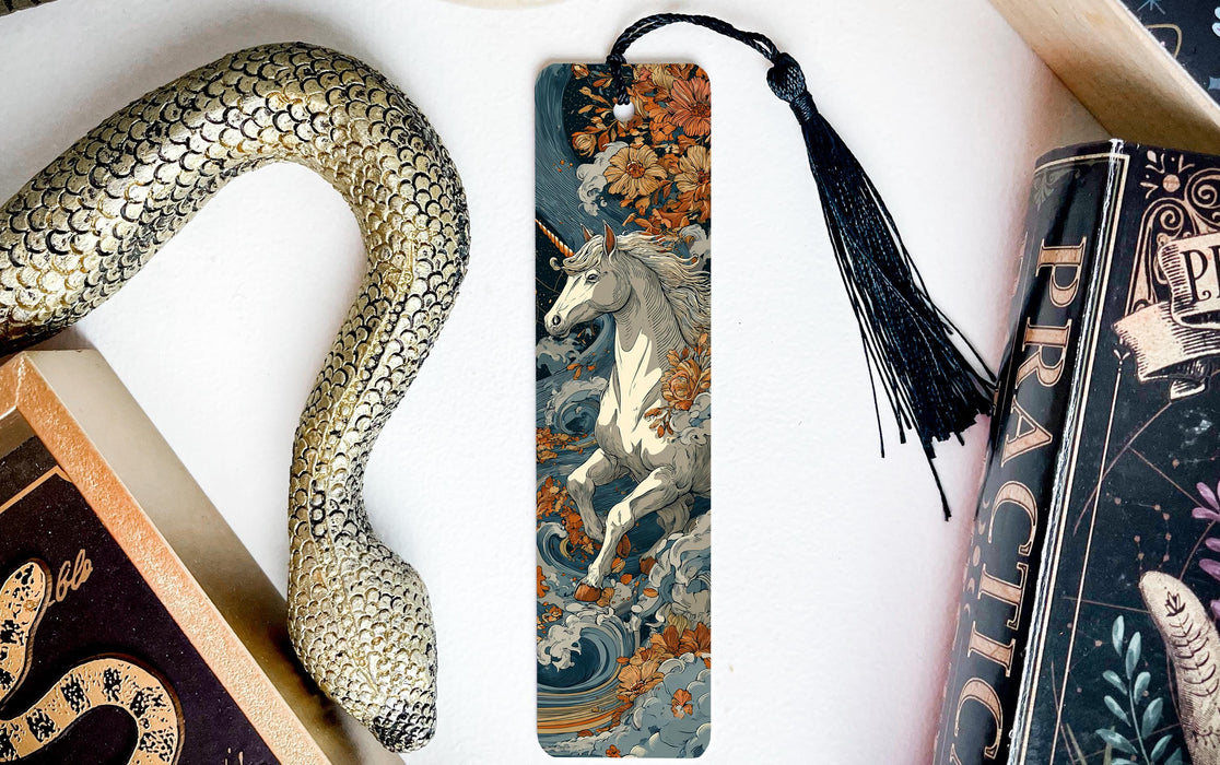 a decorative snake-shaped bookmark with a unicorn illustration on it, placed next to a book titled "Practice".