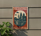 A vintage-style metal sign with a Philadelphia skyline and a bell, mounted on a wall.