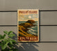 A postage stamp depicting a scenic coastal landscape with mountains, water, and a moon, mounted on a wall.