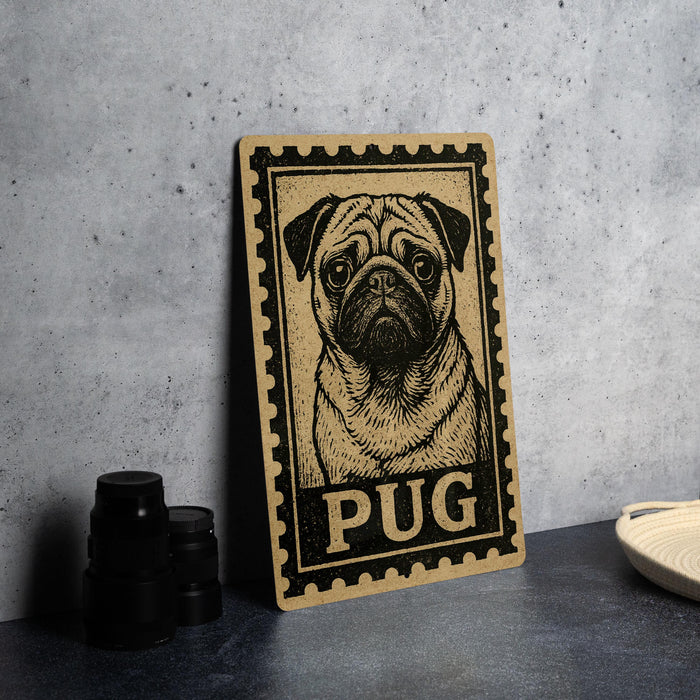 A wooden sign featuring a pug dog illustration is displayed on a table, accompanied by a stack of black camera lenses and a white dish.