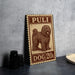 A wooden sign with a dog illustration and the text "PULI DOG 20c" is displayed on a table.