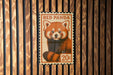 A vintage-style stamp featuring a red panda, with the text "RED PANDA" and "20¢" printed on it.