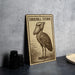 A metal sign featuring an illustration of a Shoebill Stork, a large wading bird, is displayed on a table.