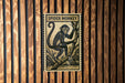 A poster of a spider monkey is displayed on a wooden wall.