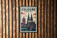 A vintage-style postage stamp depicting the Cologne Cathedral in Germany, with the text "Cologne Germany" prominently displayed.