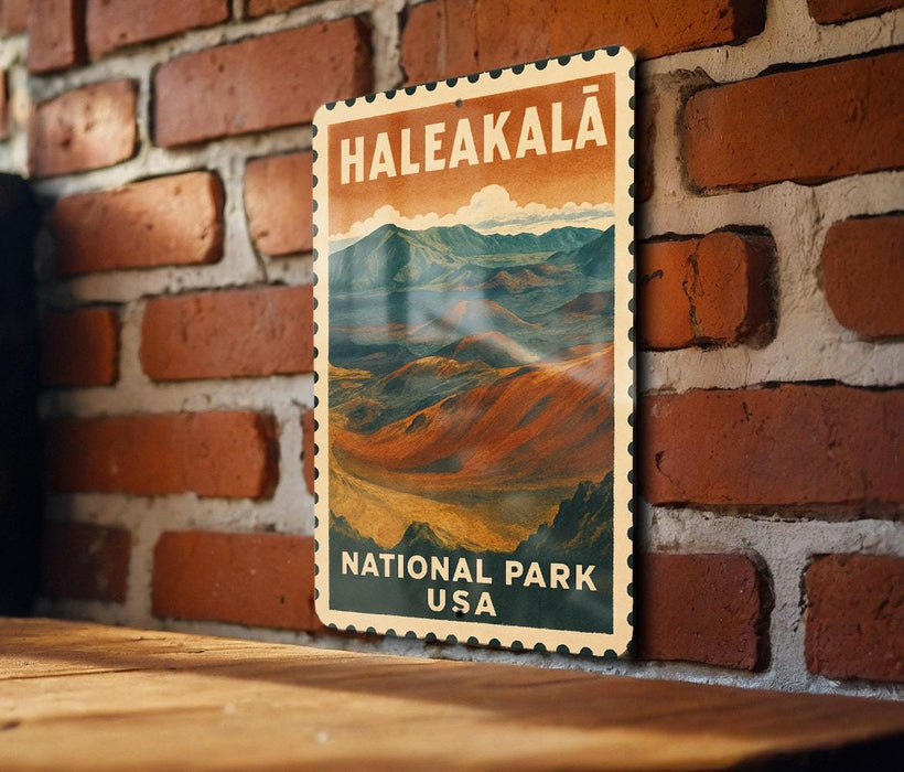 A vintage-style metal sign with the text "Haleakala National Park USA" displayed on a brick wall.