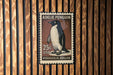 A 25c US postage stamp featuring an illustration of an Adelie penguin.