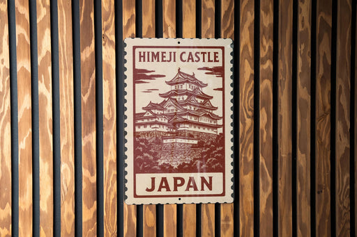 A sign for Himeji Castle, a famous landmark in Japan, is displayed on a wooden wall.