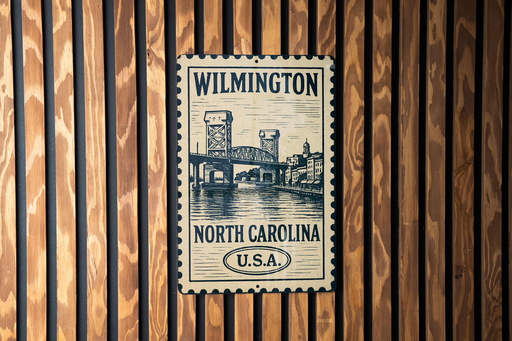 A metal sign with a drawing of a bridge and the text "WILMINGTON NORTH CAROLINA U.S.A."
