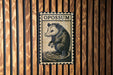 A metal sign with the word "OPOSSUM" printed on it, featuring an illustration of an opossum.