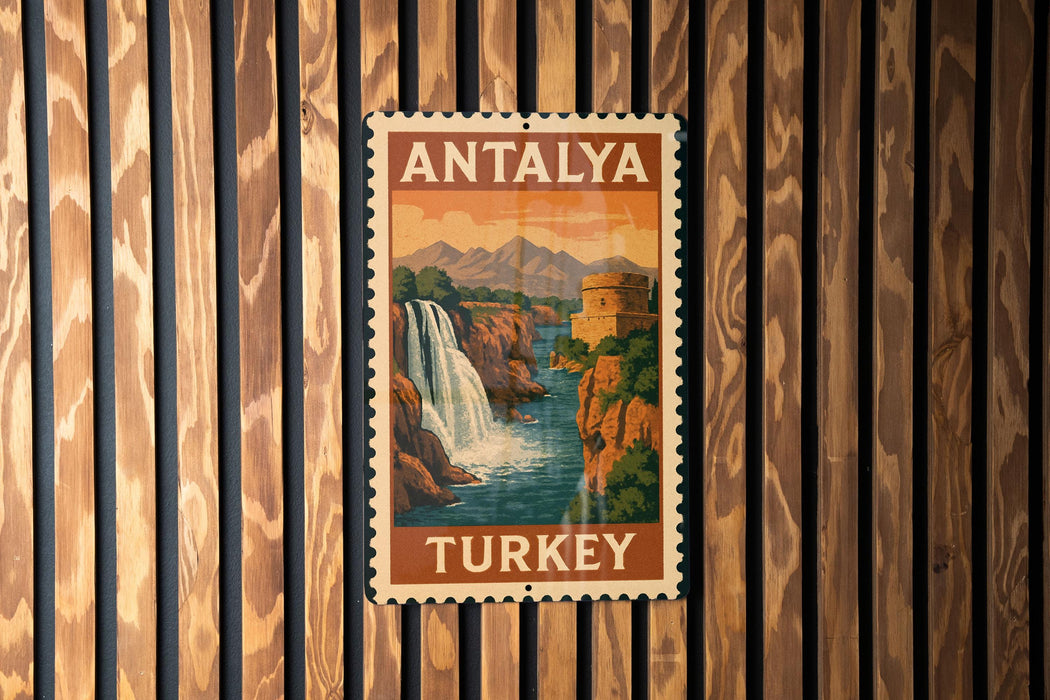 A vintage postage stamp from Turkey depicting a waterfall and mountains, mounted on a wooden wall.