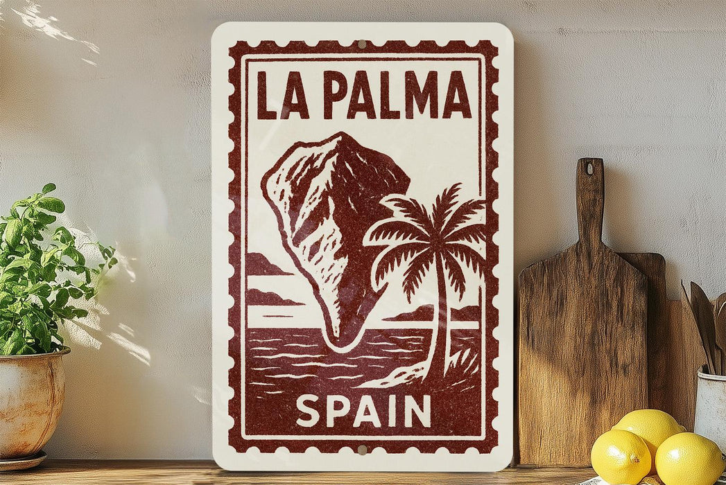 a framed poster of La Palma, Spain, with a palm tree and a mountain in the background. The poster is displayed on a shelf next to a wooden cutting board and a potted plant.