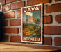 A vintage-style poster of Java, Indonesia, featuring a tropical landscape with a volcano and palm trees, is displayed on a brick wall.