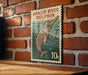 A metal sign with a picture of an Amazon River dolphin on it, mounted on a brick wall.