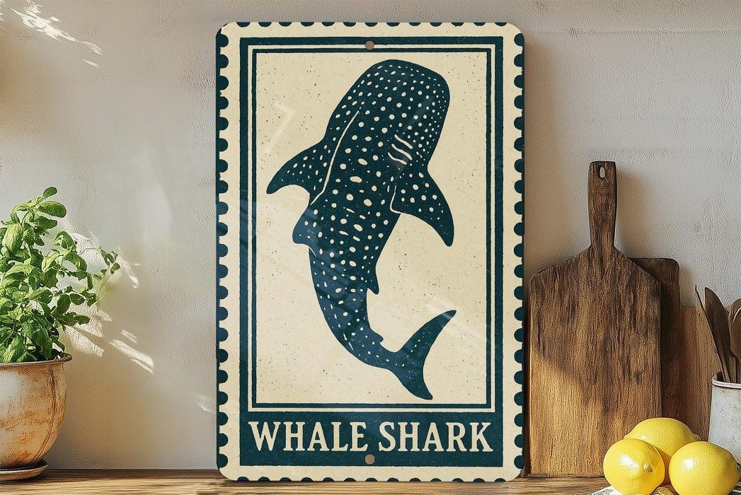 a decorative sign with a picture of a whale shark, placed on a wooden surface next to a wooden cutting board and some lemons.