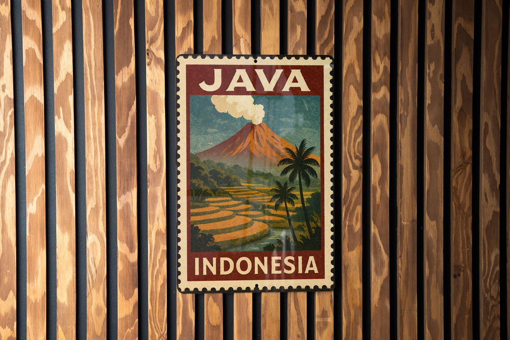 A vintage-style poster of Java, Indonesia, featuring a mountain landscape with a volcano and palm trees, is displayed on a wooden wall.