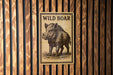 a sign with the text "WILD BOAR" and an illustration of a wild boar.