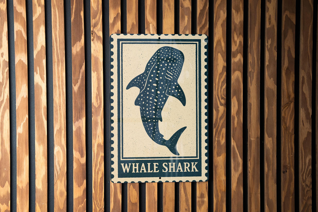 a large, spotted whale shark on a wooden wall.
