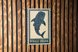 a large, spotted whale shark on a wooden wall.