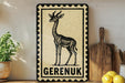 a decorative sign with a giraffe illustration, placed on a shelf next to a wooden cutting board and some kitchen utensils.