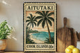 A vintage-style metal sign with a tropical beach scene, featuring palm trees and a sunset over the ocean, is displayed on a shelf next to a wooden cutting board and some lemons.