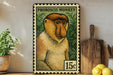 A metal stamp featuring a monkey's face, with a price of 15 cents, is displayed on a shelf next to a wooden cutting board and some lemons.