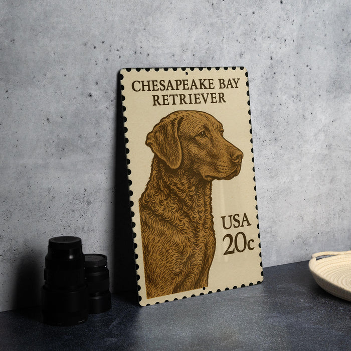 A metal stamp featuring a brown Chesapeake Bay Retriever dog, with the text "CHESAPEAKE BAY RETRIEVER" and "USA 20c" printed on it.