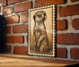 a meerkat, a small burrowing mammal native to Africa, depicted in a wooden frame against a brick wall.