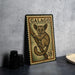 A metal plate with a printed illustration of a lemur, which appears to be a postage stamp, is displayed on a table.