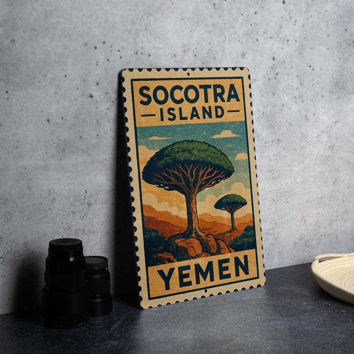 a vintage-style metal sign with a tree illustration, placed on a gray countertop next to some black camera lenses.