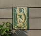a sign with a monkey illustration on it, mounted on a wall.