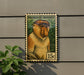 A stamp-like sign featuring a close-up of a proboscis monkey, with the text "PROBOSCIIS MONKEY" and a value of 15 cents.