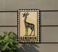 a sign with a giraffe illustration and the word "Gereuk" written on it, mounted on a wall.