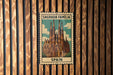 A metal sign with a picture of the Sagrada Familia, a famous cathedral in Barcelona, Spain.