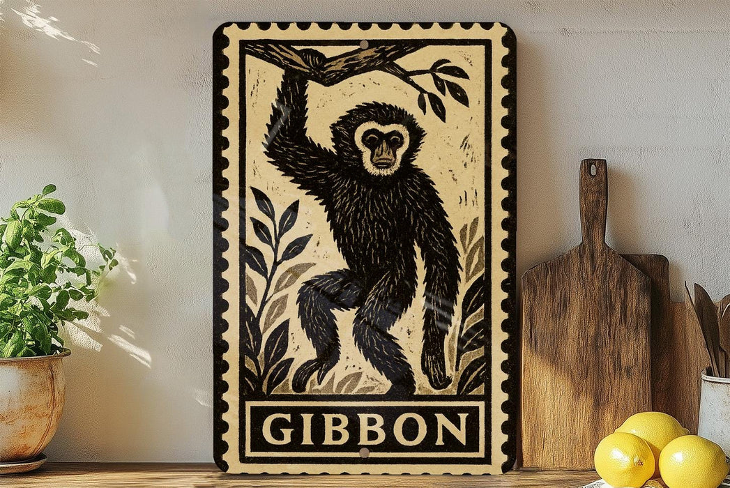 a framed illustration of a monkey, with the word "GIBBON" written below it. The monkey is depicted in a playful pose, with its arms raised above its head. The frame is placed on a wooden surface, with a potted plant and a cutting board nearby.