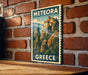 A vintage-style metal sign with the text "METEORA GREECE" is displayed on a brick wall.